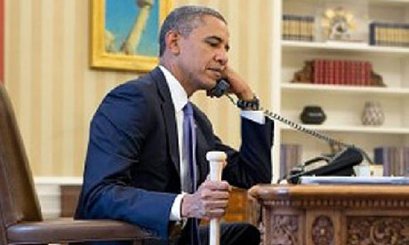 Obama holds baseball bat whilst on the phone to the TUrkish president.